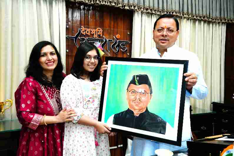 Erika Saini of class 7th, Montfort School, Roorkee, presented a handmade portrait of the Chief Minister of Uttarakhand