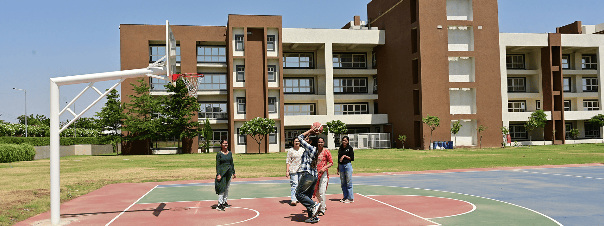 Students walking and interacting on green campus lawn at Tribhuvan College